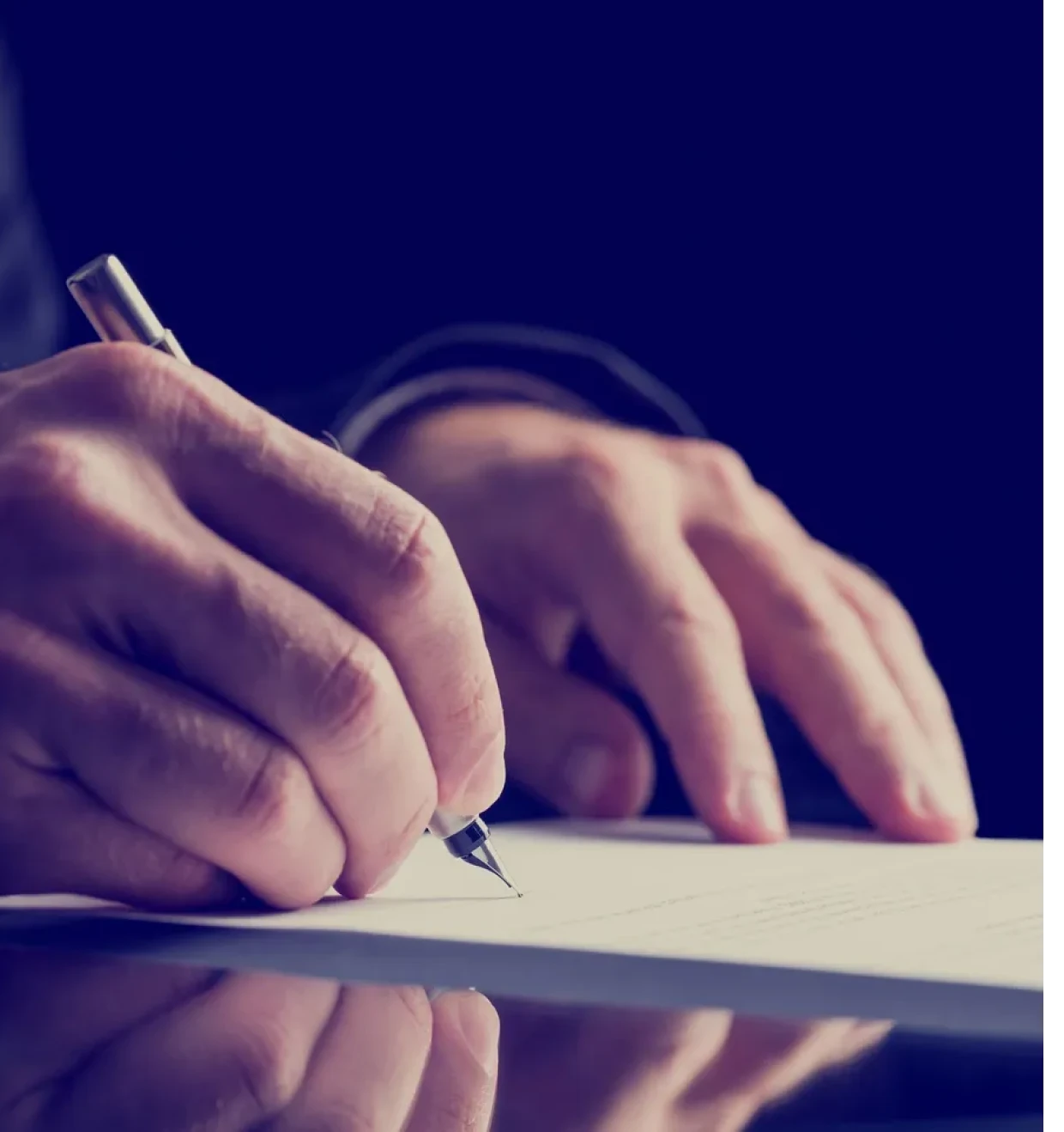 Hands writing on a document